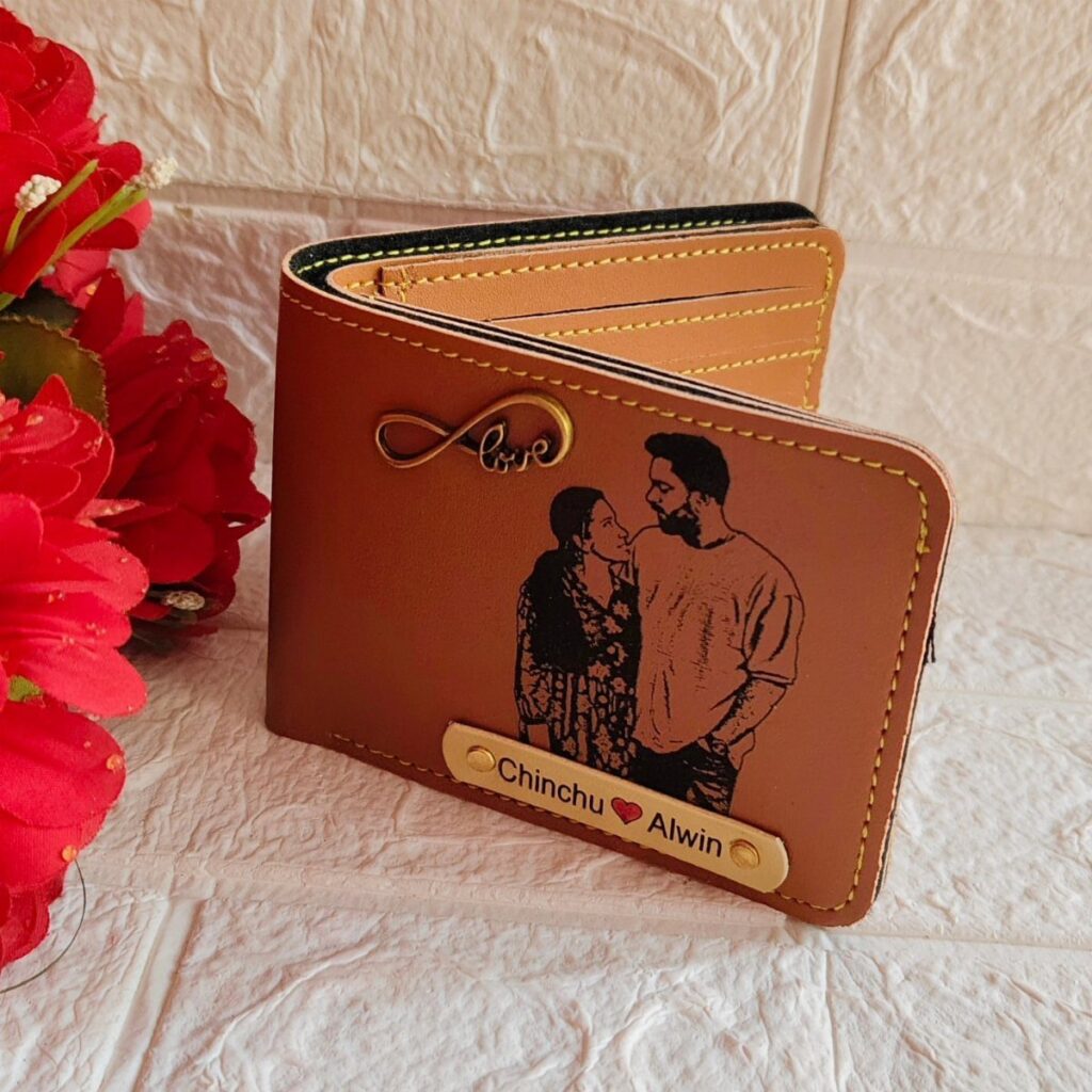 Brown leather wallet personalized with a couple's photo and names on a nameplate.