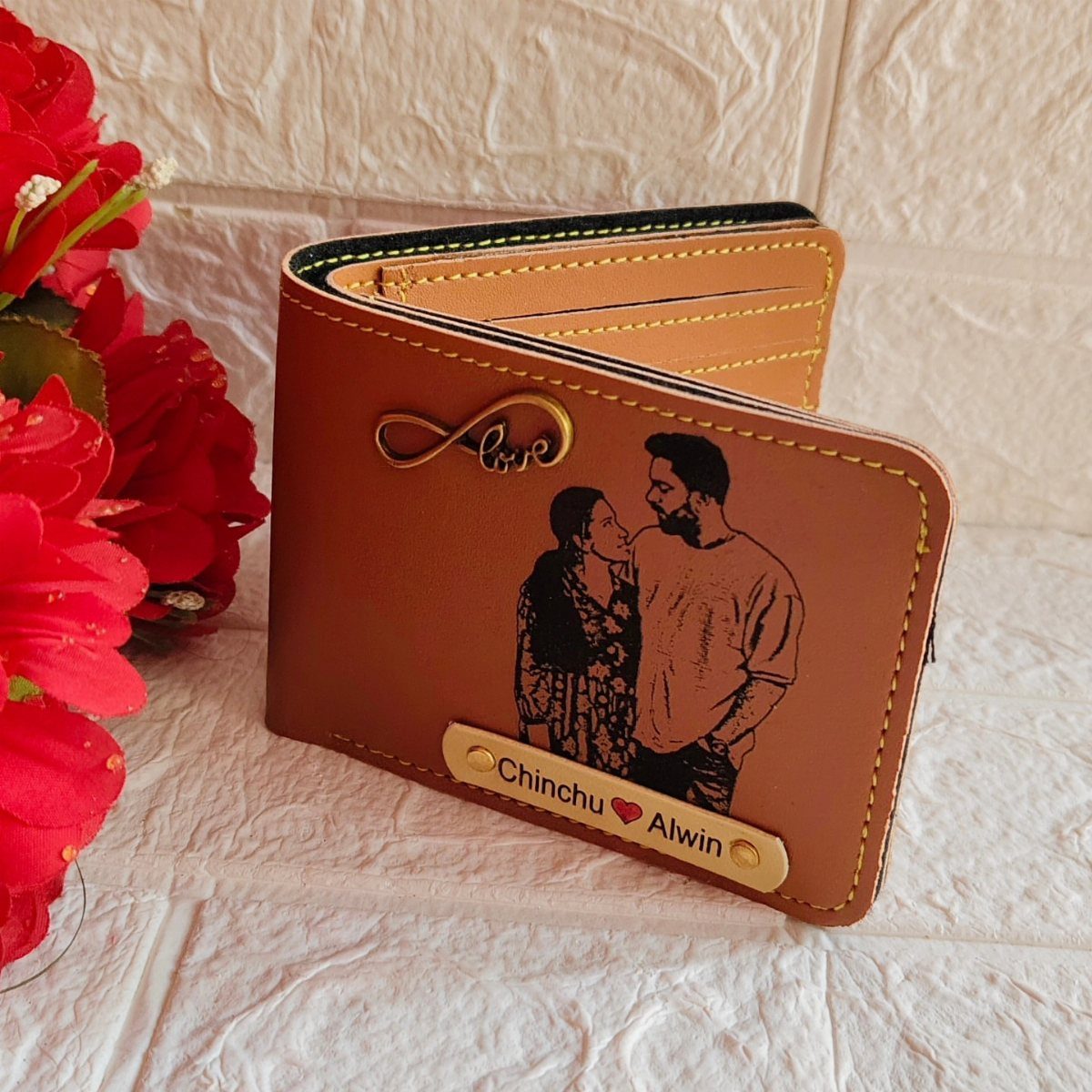 Brown leather wallet personalized with a couple's photo and names on a nameplate.