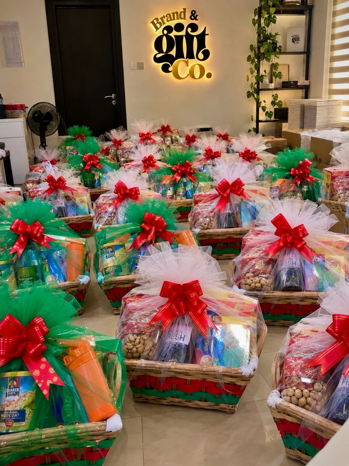 Wicker gift baskets wrapped in cellophane with red bows and festive tulle decorations.