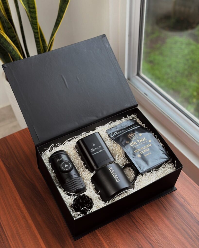Coffee gift set in a black box with a travel mug and beans.