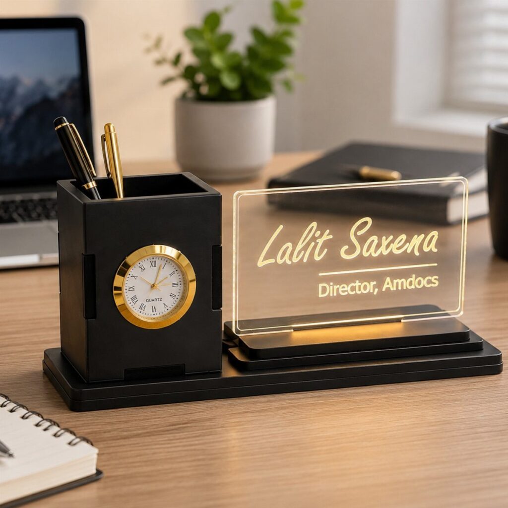 Black desk organizer with a gold clock and personalized acrylic nameplate on wooden table