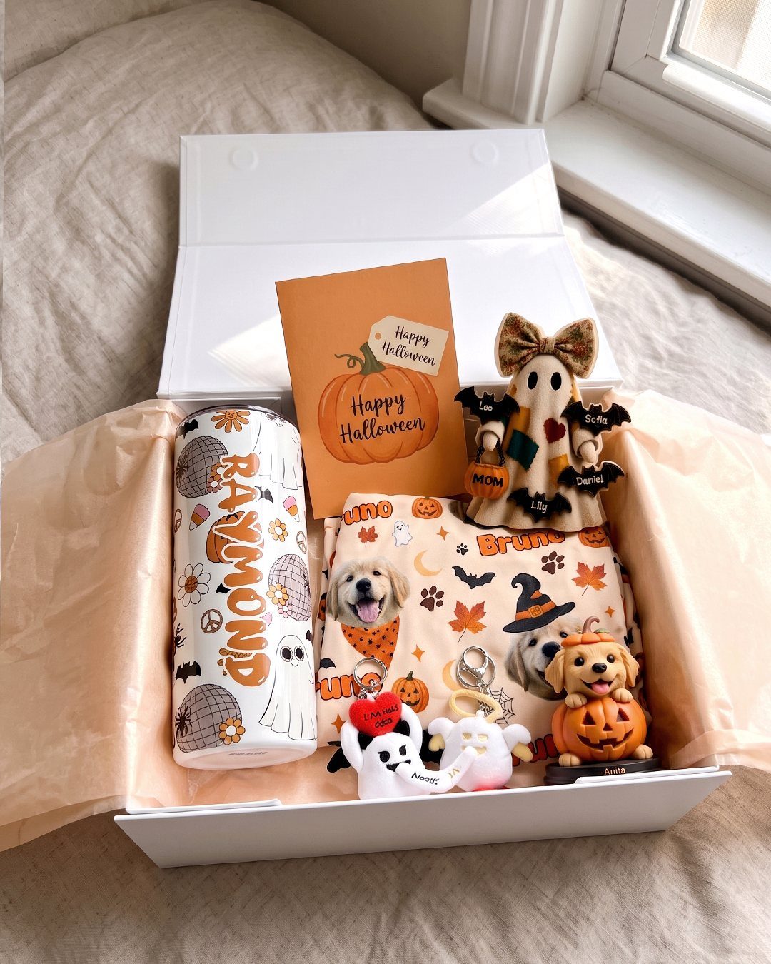 Halloween gift box with personalized Raymond tumbler, ghost plush, and dog-themed accessories.