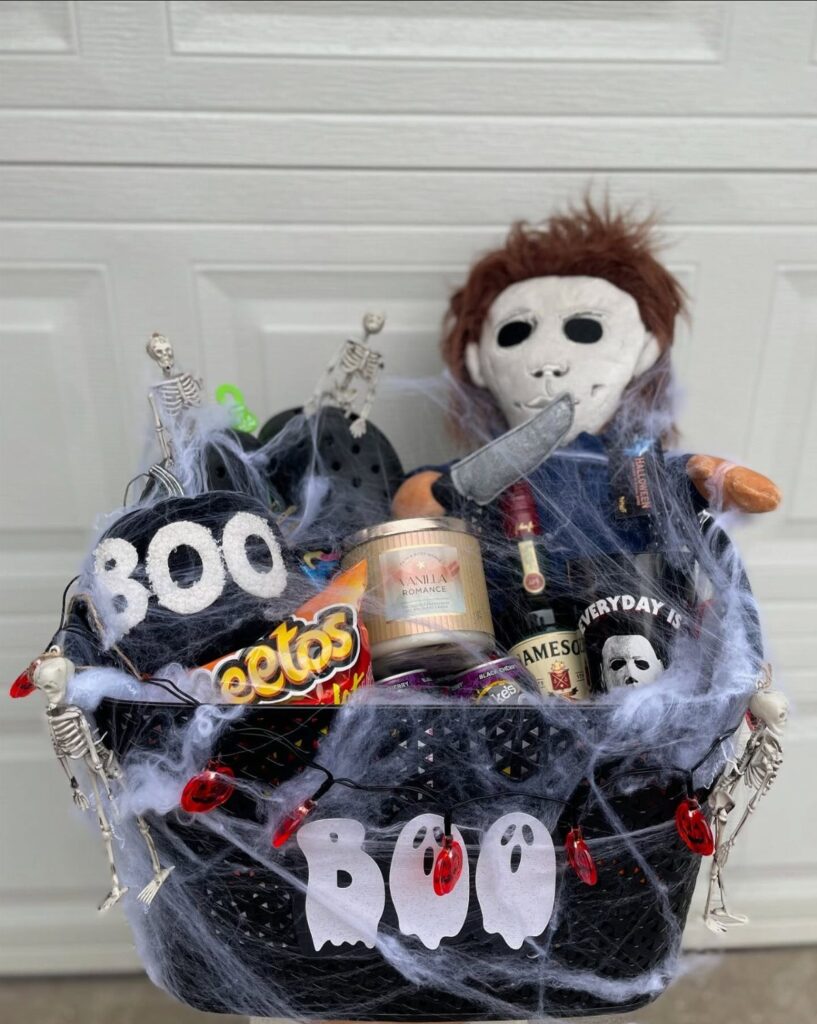 Halloween gift basket with Michael Myers plush, snacks, and spooky spiderweb decorations.