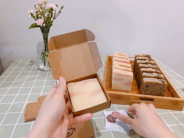 Hand soap bars in a gift box and on a wooden tray with flowers