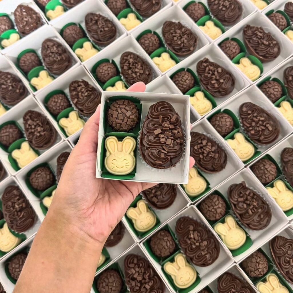 Hand holding a small box of bunny and egg shaped chocolates