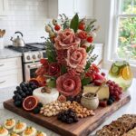 Wooden charcuterie board featuring salami roses, assorted cheeses, nuts, and fresh fruits.