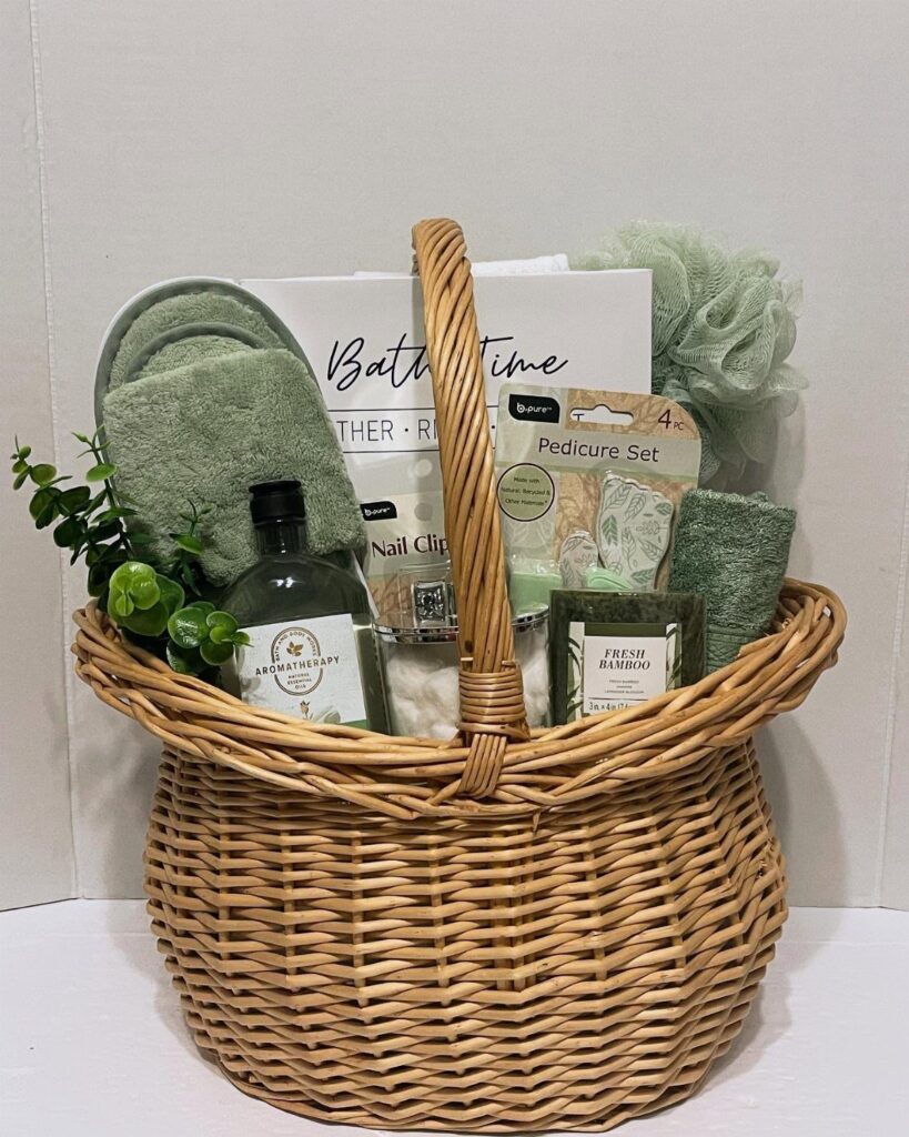 Woven wicker basket filled with green spa products, slippers, and bath accessories.